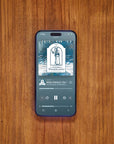 Phone displaying Apple Podcast The Gnomes of Wondergarten on wooden table