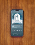 Phone displaying Apple Podcast The Gnomes of Wondergarten on wooden table